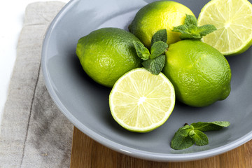 lime and mint in a plate close up. © ytochka89