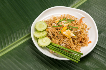 Fried Rice Sticks with Shrimp in white dish on banana leaf