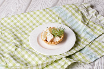 Tartlets with chicken and zucchini on white background