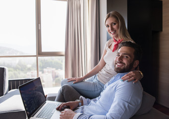 couple relaxing at  home using laptop computers