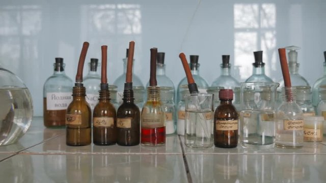 Colored bottles and flasks with reagents are in chemical laboratory in the University, College, School
