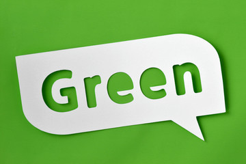 Green text cut-out on comic bubble over green background