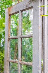 Opened vintage wooden door to  green garden