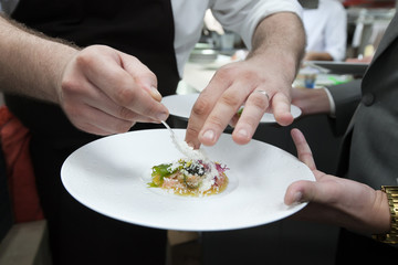 Chef cooking food with Caviar and shrimp for dinner party in the restaurant kitchen.