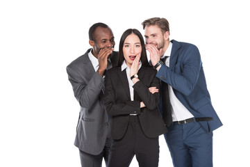 portrait of multiethnic businessmen telling secret to asian businesswoman isolated on white
