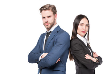 side view of multicultural business colleagues with arms crossed standing back to back isolated on white