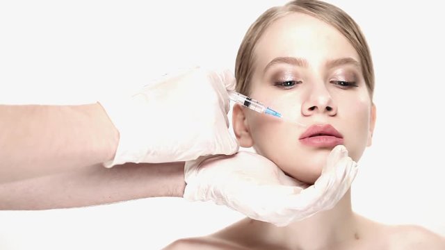 Portrait of woman getting botox cosmetic injection in upper lip
