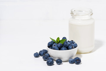 Fototapeta na wymiar fresh blueberries and a bottle of milk