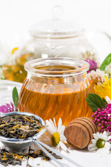 fresh flower honey, tea and ingredients, vertical closeup