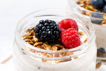 healthy creamy dessert with berries in jars