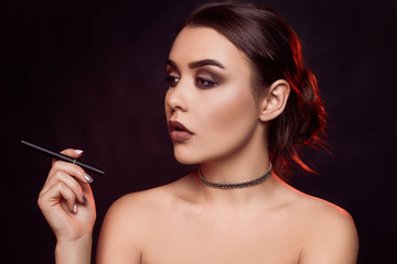 Fototapeta premium Glamour seductive gorgeous brunette woman smoking electronic cigarette