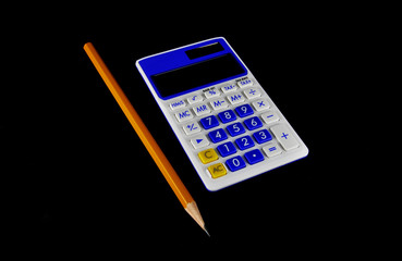 Calculator and pencil on a black background closeup. Business, electronics, office