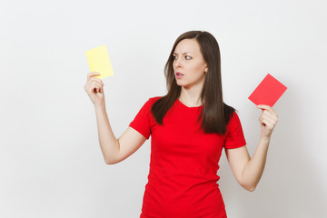 European serious severe young woman, football referee hold choose yellow and red soccer cards,...