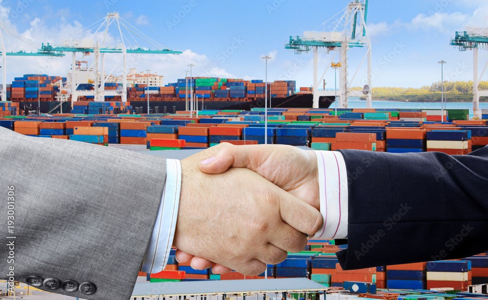 Aufkleber Closeup of business people handshake on container terminal with cranes background 