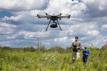 People playing with RC quadrocopter 
