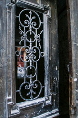 Old Iron Lace Door with Wooden Frame in City House