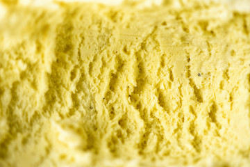 Scooped vanilla ice cream background. Summer food concept, copy space, top view. Sweet yogurt dessert or yellow ice-cream texture.