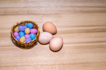Easter eggs in a basket on a wooden background