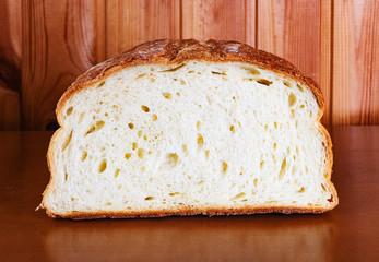 Fresh bread slice on wooden table