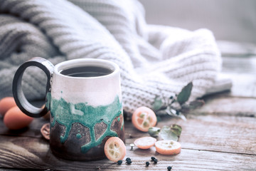 still life a cozy cup of tea with kumquat on a wooden background, the concept of coziness and pastime
