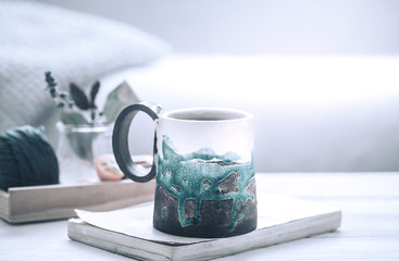 book and a cup of tea on a wooden background, the concept of coziness and pastime
