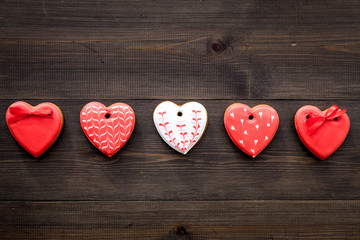 St Valentine's Day cookies in shape of heart on dark wooden background top view copy space