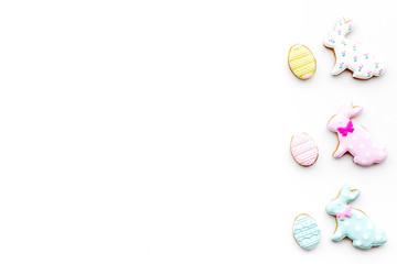 Sweets, pastry for Easter table. Easter eggs and Easter bunny concept. White background top view space for text