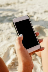 Female hand holding smartphone with blank screen