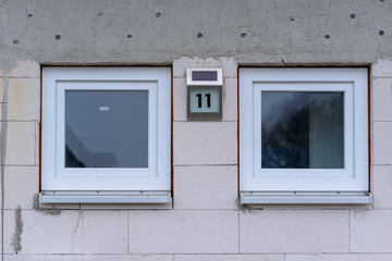 Fototapeta na wymiar Two identical small square windows