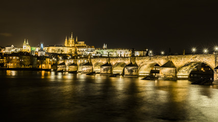 Charles bridge reflected in the Vltava river