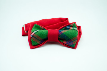 Stylish and well-designed red-green bow-tie on a white background; isolated