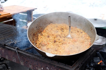 Pilaf in kazan - national Asian food from rice, meat and vegetables.