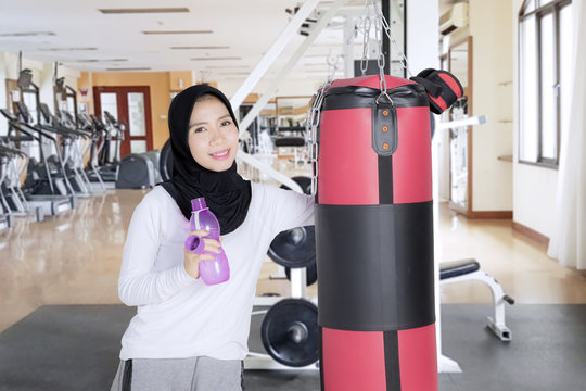 Muslim woman posing after an exercise in a gym