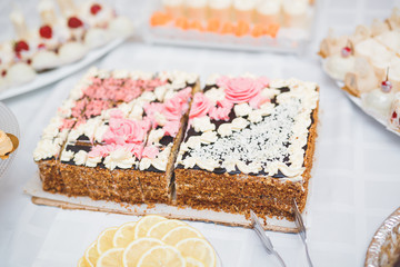 Delicious and tasty dessert table with cupcakes shots at reception closeup