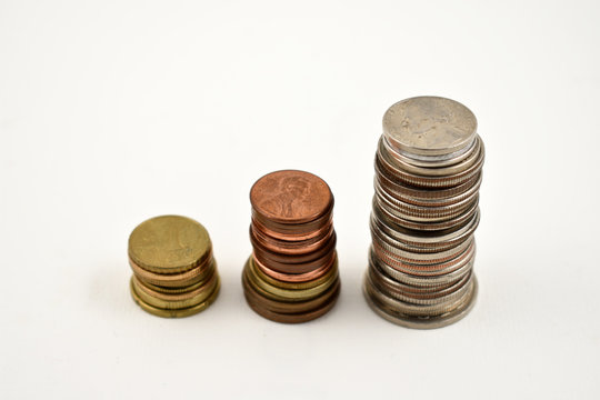 Coin stack stock images. Different coins on a white background. Different types of currencies