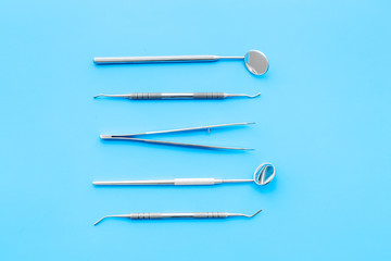 Dentist tools. Prevention of diseases of the oral cavity. Dentist appointment. Blue background top view
