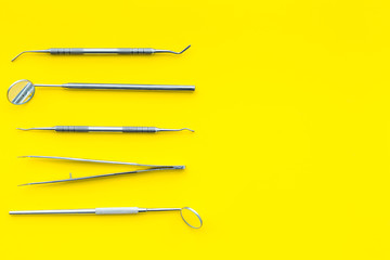 Dentist tools. Teethcare, dental health concept. Yellow background top view copy space