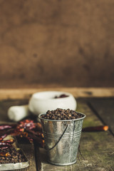 Fototapeta na wymiar black pepper peas - spices - new crop on a wooden surface