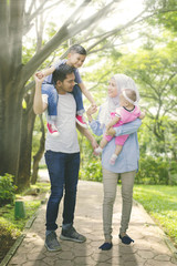 Fototapeta premium Medium shot of asian muslim family having a good time