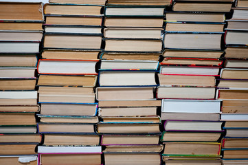 A stack of different books of new and old folded vertically