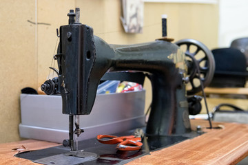 An old sewing machine is good at producing exclusive handmade hats from the thick wool material