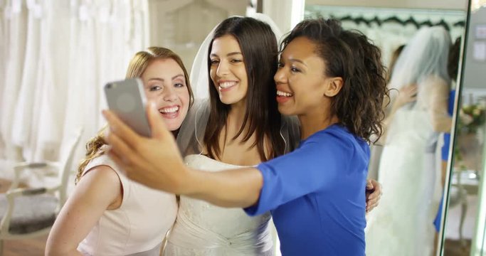 4k, Young woman taking pictures with friends at a bridal store.