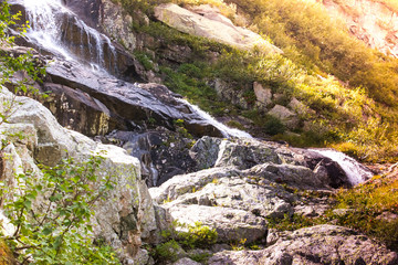Fototapeta na wymiar Mountain waterfall on a summer day