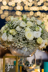 White rose bouquet set up on reception night wedding with boken at night.