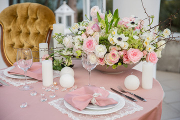 Beautiful wedding table that decorated with flower arrangements and candles.