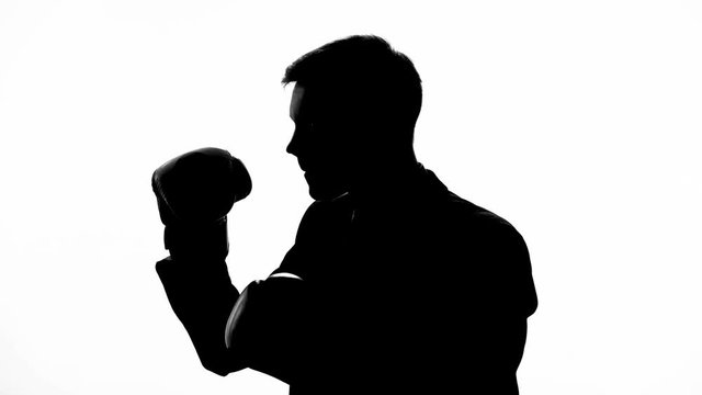 Shadow of man in business suit boxing with shadow, stress relief, way to reflect