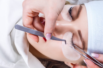 Obraz na płótnie Canvas Eyelash Extension Procedure. Woman Eye with Long Eyelashes. Lashes, close up, selected focus.