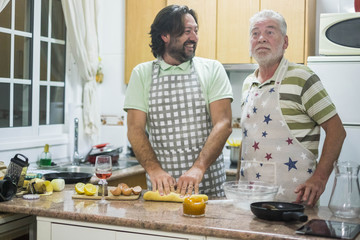 men at work in the kitchen at home with funny expression doing a cake together