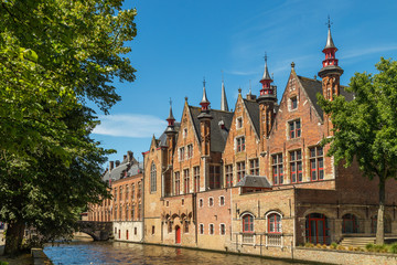 Obraz premium Typical medieval Flemish architecture of Bruges, Belgium. Red brick houses standing on canals