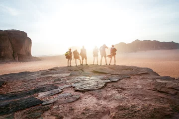  Tourist friends on a top of mountains in a desert. Sunset view. Nature. Tourist people enjoy a moment in a nature. Wadi rum national park - Jordan  © tibor13